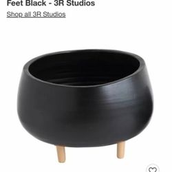 large indoor houseplant pot with wooden legs 