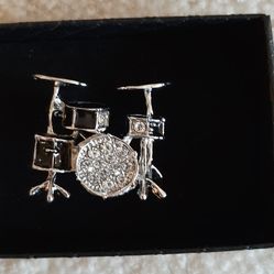 Silver-tone drum set charm pinshaped.