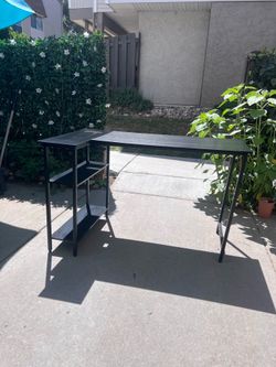 Black L-shaped desk with shelves