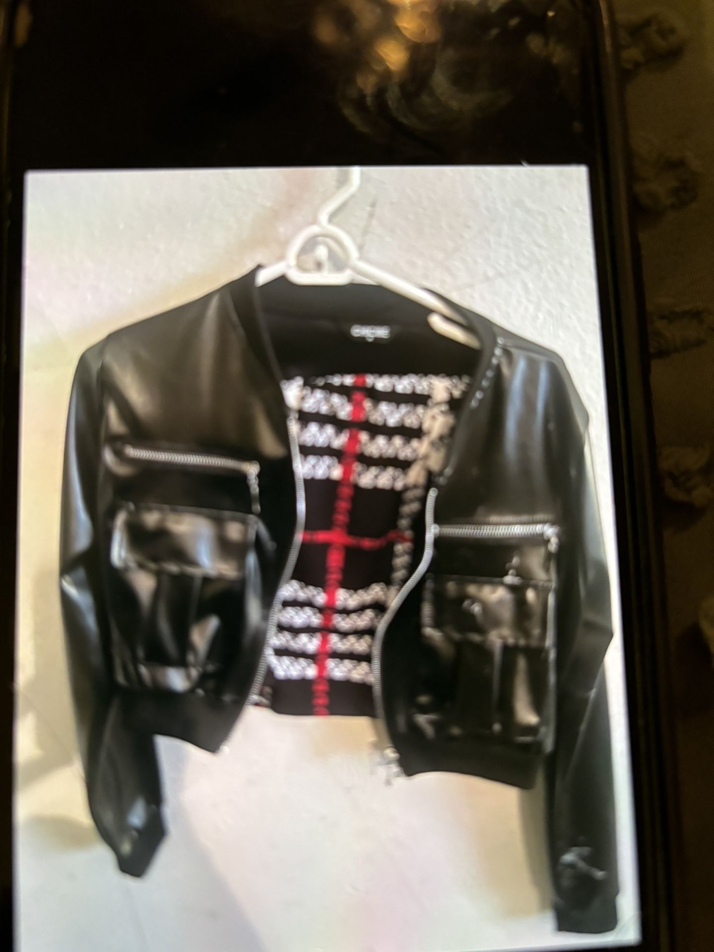 Women’s size medium leather jacket, crop top style inside is a black red and white mini skirt with a slit up the side also a size medium