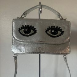 Betsy Johnson Silver Black Eye Top Handle Crossbody Purse.. pre owned very good condition.. This bag is so cute and very fashionable! This purse has c