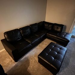 black leather L shaped couch with ottoman