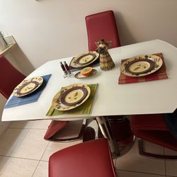 White Glass Table and Red Chairs