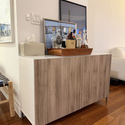 Modern white & oak storage cabinet with glass top.