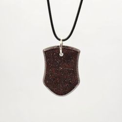 Stardust II Orgonite Pendant, Provides EMF Protection, And  Balance. 

Contains: 
Red jasper, black obsidian, metal, and resin. 

"Embark on a journey