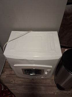 Portable washer and dryer for sale hooks up to sink or hose and uses regular electricity current. Never been used , but does have some dents in it