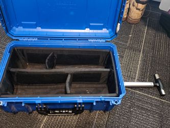 Water proof case with wheel and a pull behind handle with two carrying handles