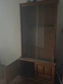 Large wooden glass front gun cabinet