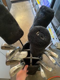 Golf clubs w tees, balls, gloves.