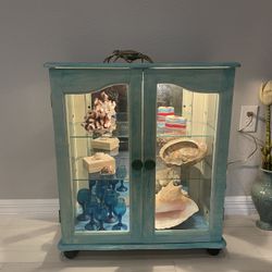 Artistic painting of a coastal style floor cabinet