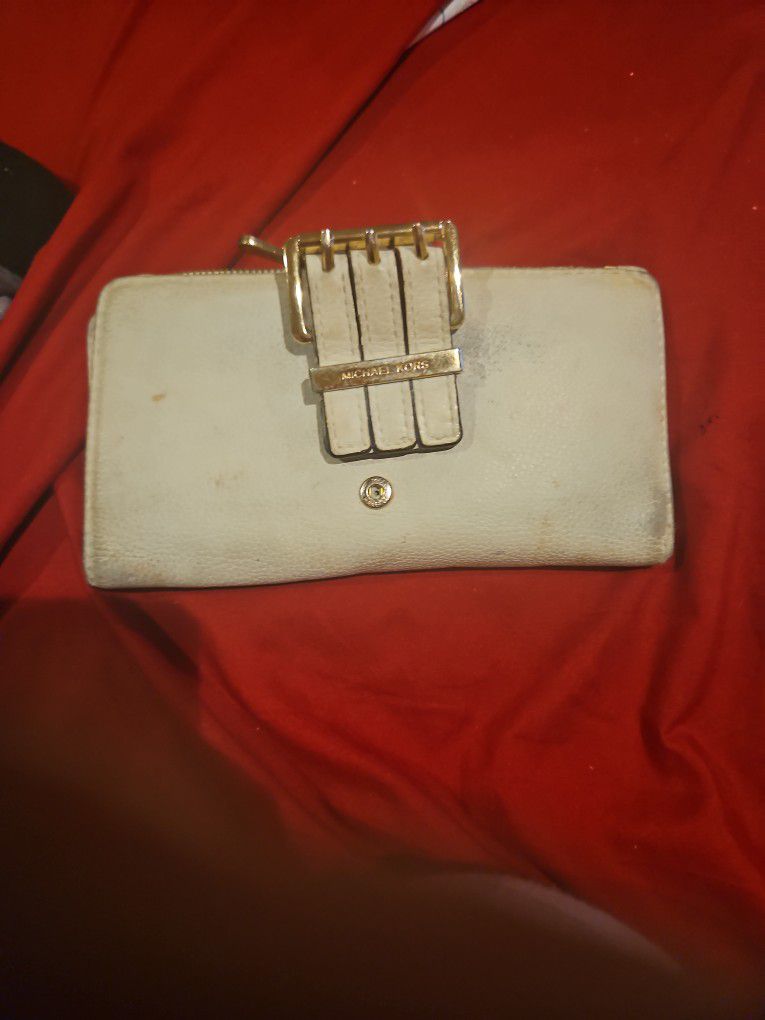 Used Michael Kors beige Wallet.  Has Many Cardholders And Zipper Pouch For Coins And Cash Slot