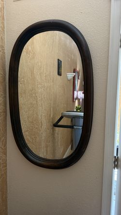 Dark wood oval mirror