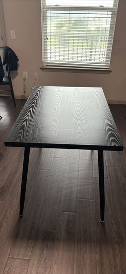 Modern black table with three chairs