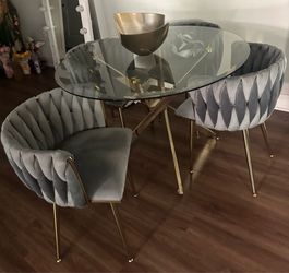Glass dinning table w/ grey velvet chars