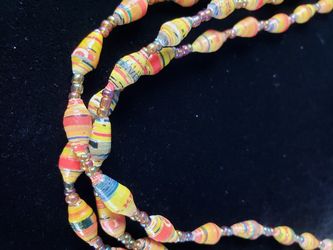 $10. Recycled bead necklace! Triple strand newspaper bead necklace. Handmade in Uganda. 20 inches long. Beads are 1/4 in wide. 86 total paper beads.