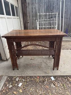 Antique wicker and wood library table from early 20th century.