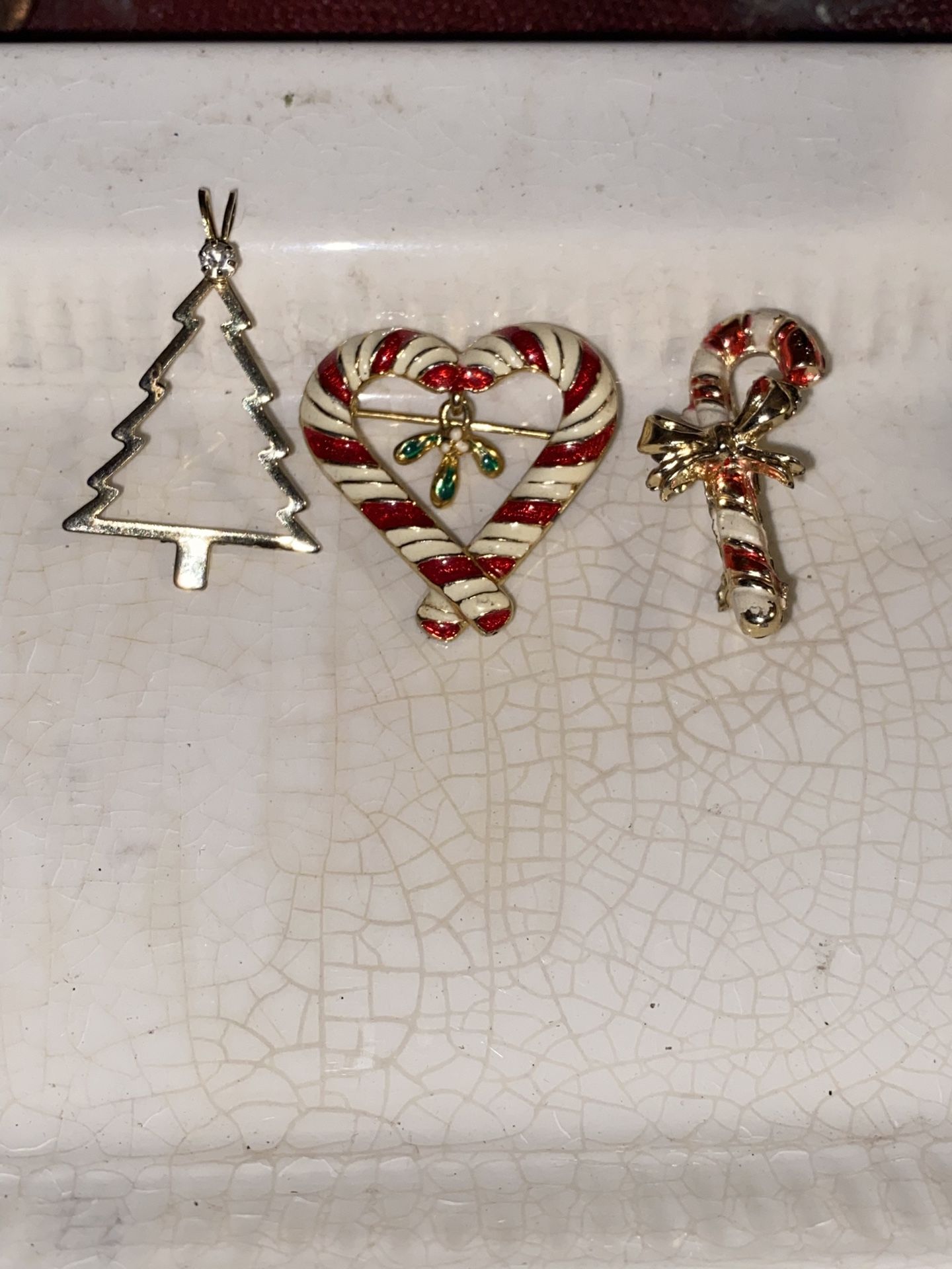 Vintage go toned with the enamel paint, heart, candy, cane, and a candy, cane pens, and a go to Christmas tree with a simulated diamond