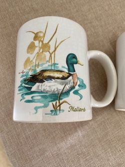 The NOS Vintage Japan DE Miller Duck Coffee Mugs are a charming set of four-piece ceramic and porcelain mugs featuring a ducks pattern, specifically m
