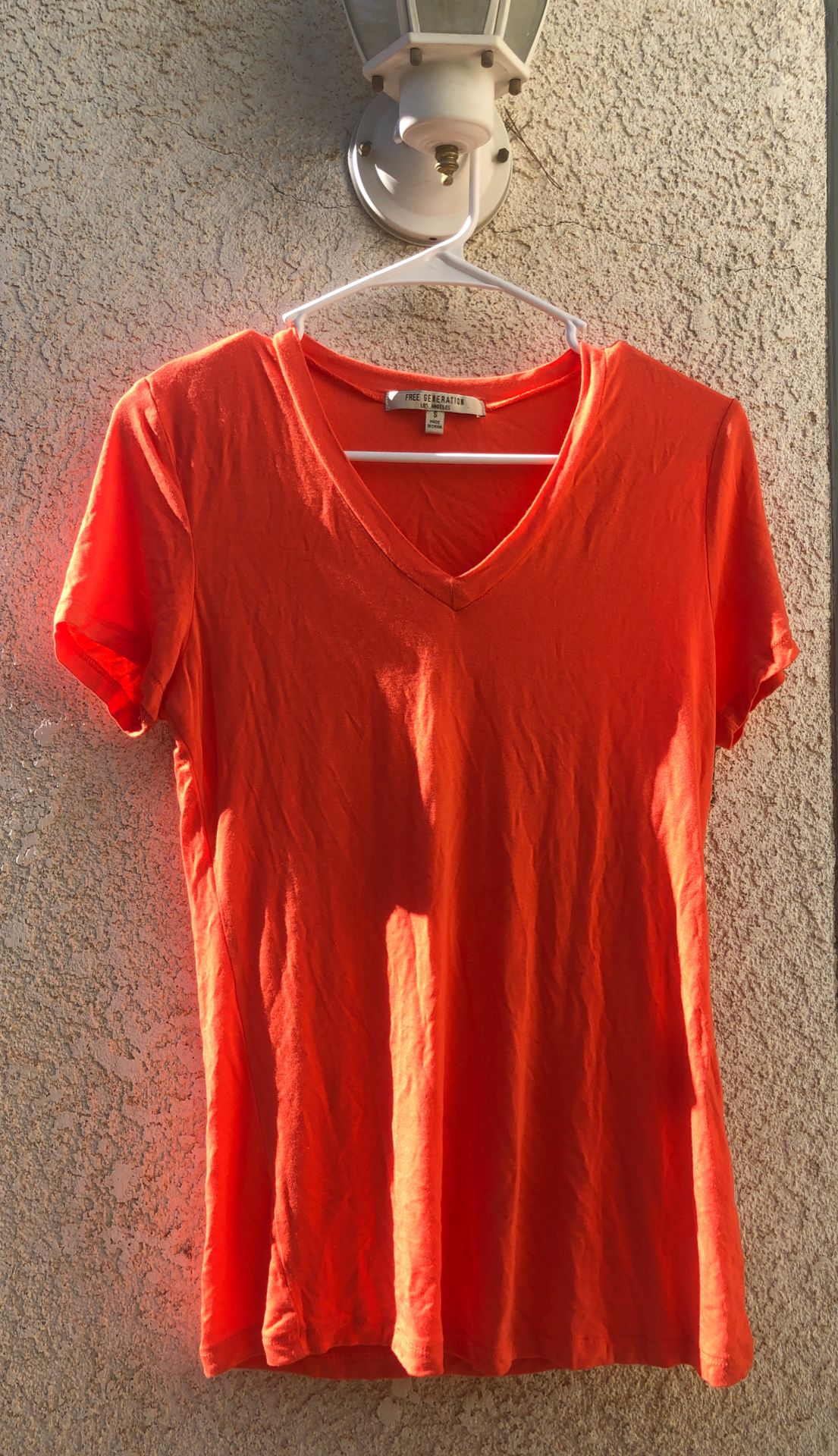Women’s small orange V-neck top