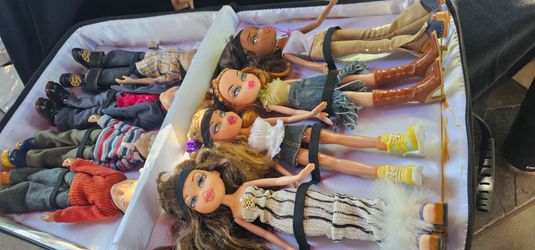 2000s Bratz and Bratz Boyz fashion dolls packed inside a soft-sided carrying case.