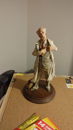 Vintage statue of elderly Dr. With stethoscope and bag on wooden base