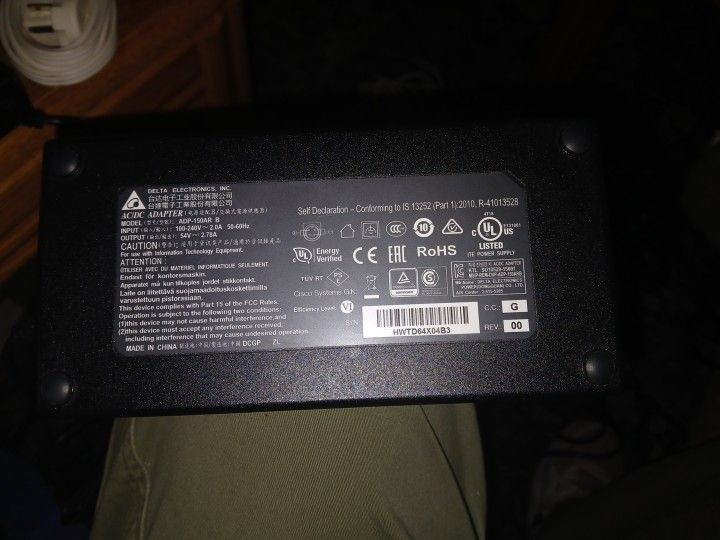 This image displays an AC/DC adapter manufactured by Delta Electronics, Inc.