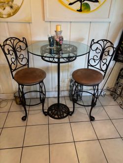 High top glass table with two chairs.. 32” around x 44” high $100 Delivery available for a small fee