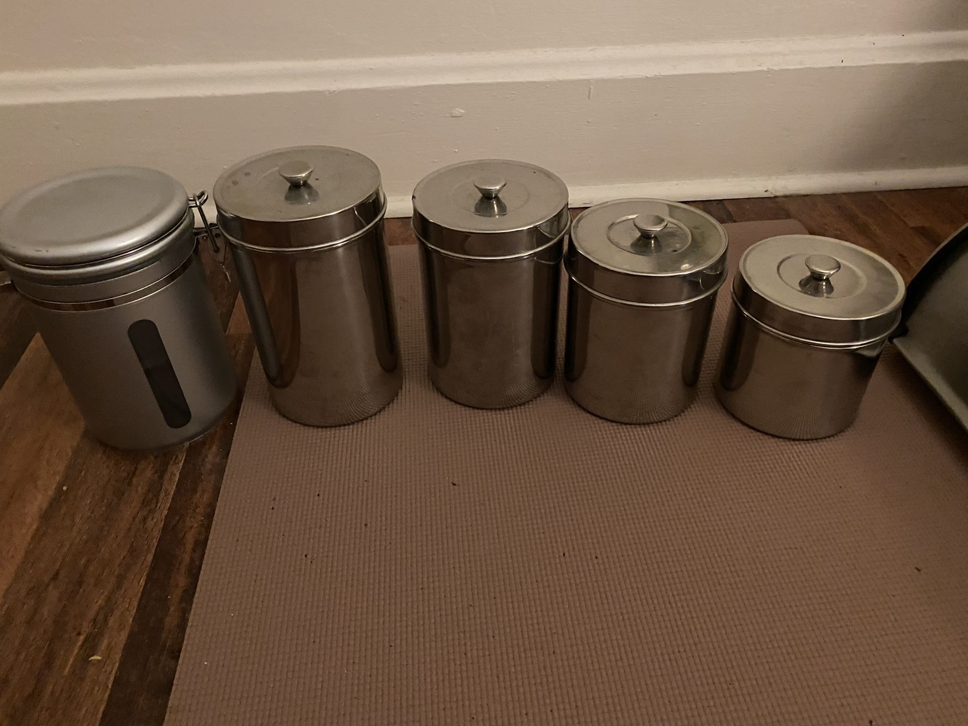 Four matching stainless steel storage containers