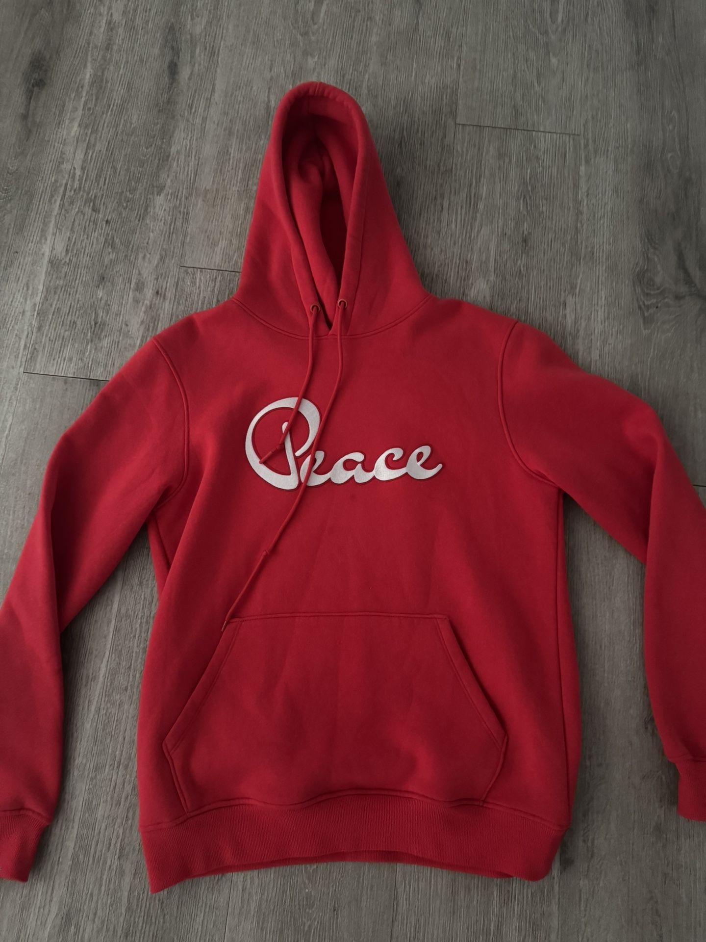red “peace” hoodie resembling an angel