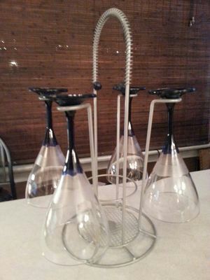 4 long stem plastic wine glasses and metal stand. Great to use outdoors or anywhere..great gift idea .. Used for staging purposes