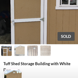 Tan Wooden Storage Shed with White Trim