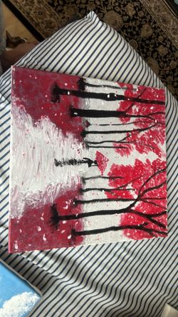 This handmade acrylic canvas painting captures a striking, stylized landscape featuring black silhouettes of trees with vibrant red foliage, falling p