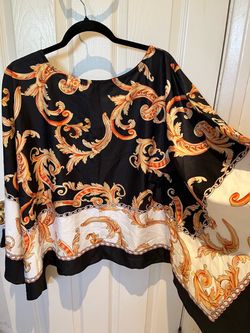 Suit for a woman Two pieces. Top has to the sleeves that flow outward