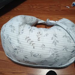 Nursing pillow with a belt strap.