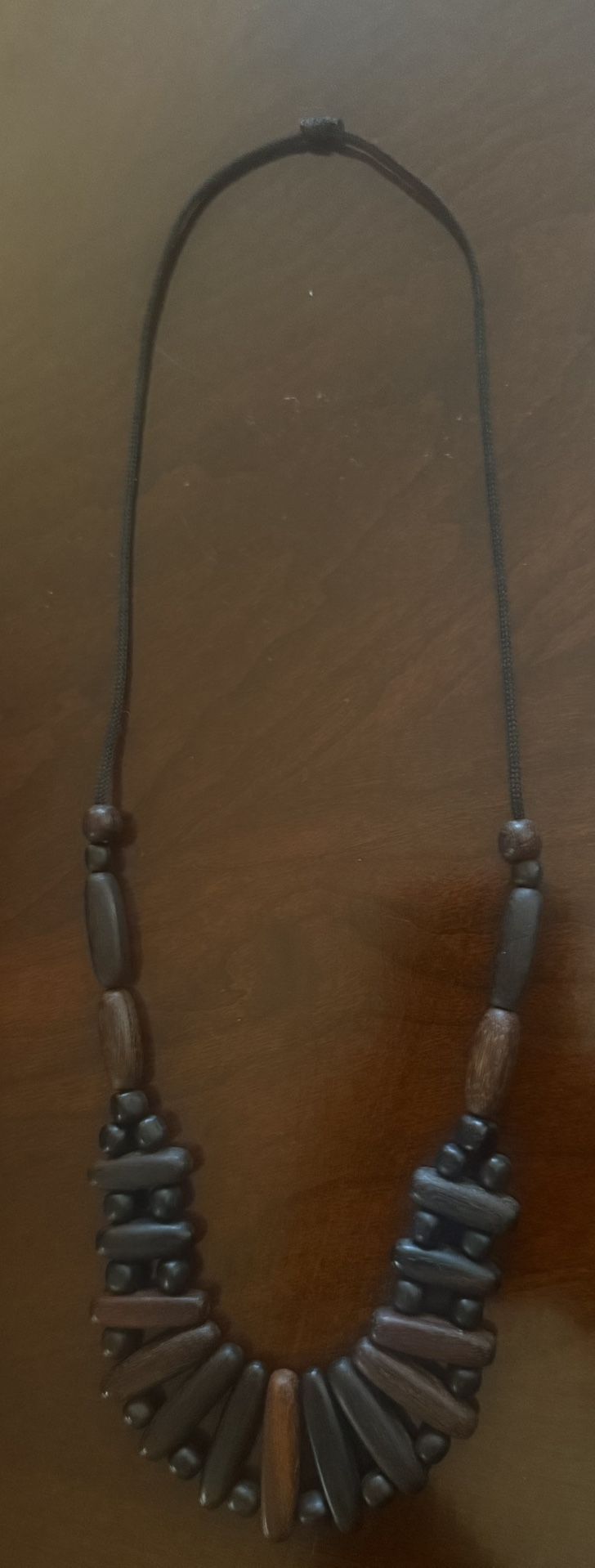 beaded necklace made of dark wood and coconut beads