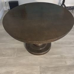 Round dining room table seats four comfortably