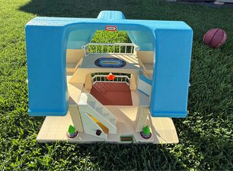 This is a vintage 1989 Little Tikes dollhouse featuring a blue roof and white walls