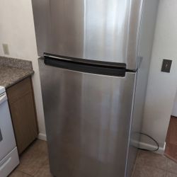 Whirlpool stainless steel refrigerator with top freezer.