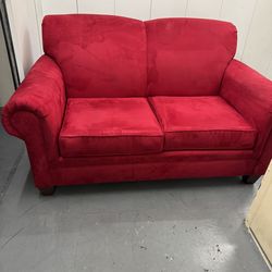 Red micro fiber upholstered love seat and matching side chair.