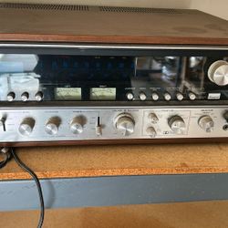 The product in the image is a vintage Sansui 9090DB stereo receiver. It is a highly sought-after audio component