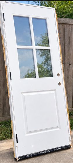 white exterior entry door with four glass panes and one raised lower panel