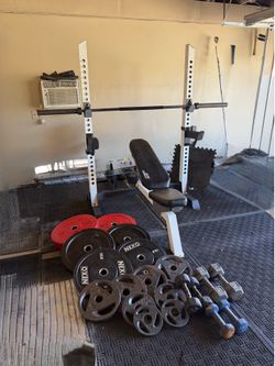 Bench press/squat rack with 7ft 3 piece bar and 290lbs of Olympic weights plus dumbbells