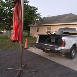 10' Tall Cantilever Umbrella Stand(Umbrella Needs Cleaning Or Replaced)