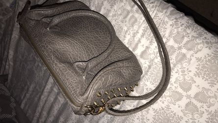Gray handbag also switches into cross body bag
