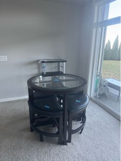 Small dining table perfect for small spaces comes with four chairs that can be tucked inside when not using