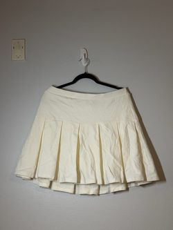 When Good Meets Bad Pleated Mini Cream Skort from Fashion Nova