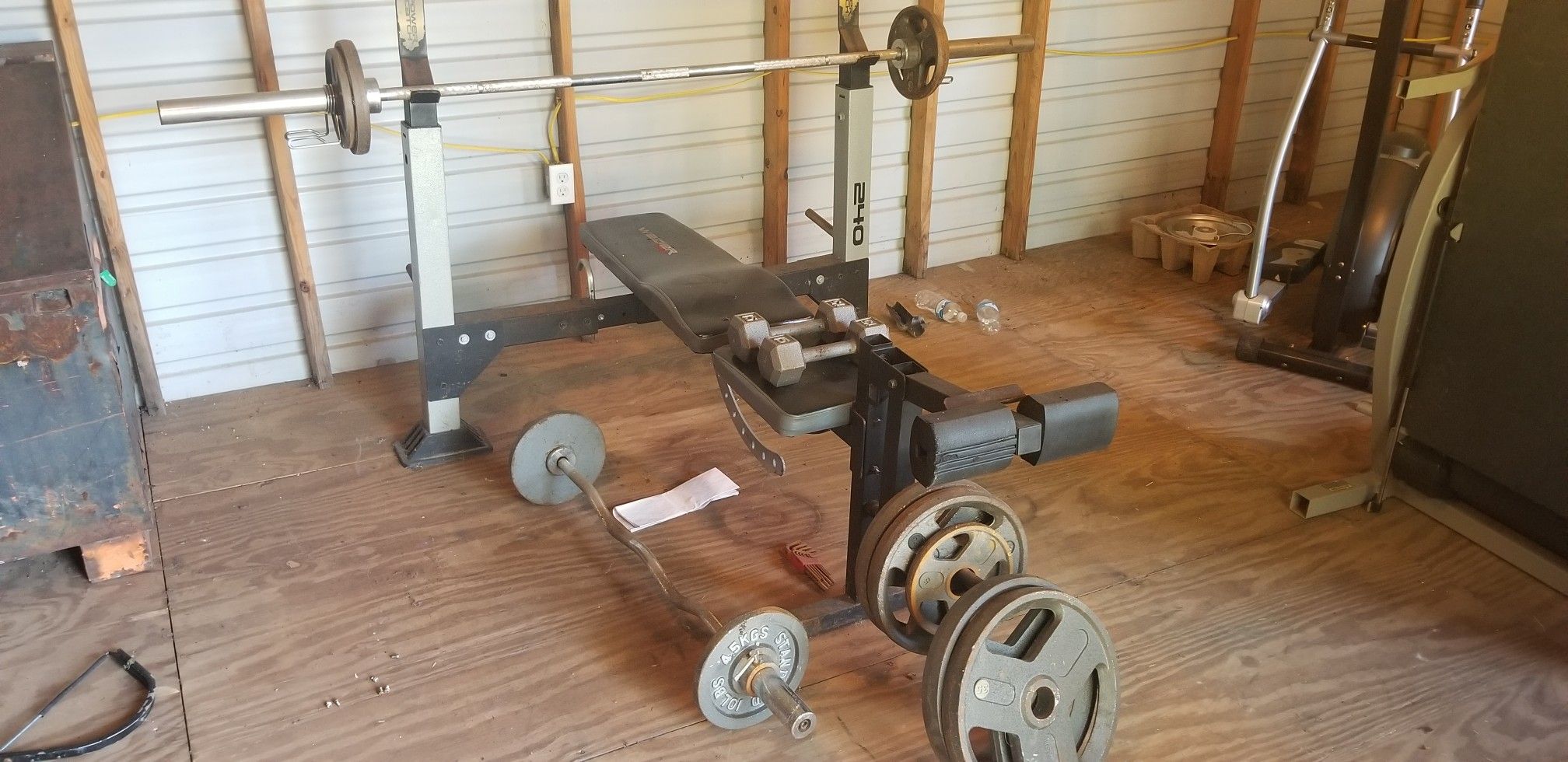 Weight bench, curlbar, barbell, dumbbells, and weight plates