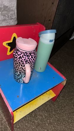 Cheetah print Coffee cup and another cup  and jean shorts and a tang top