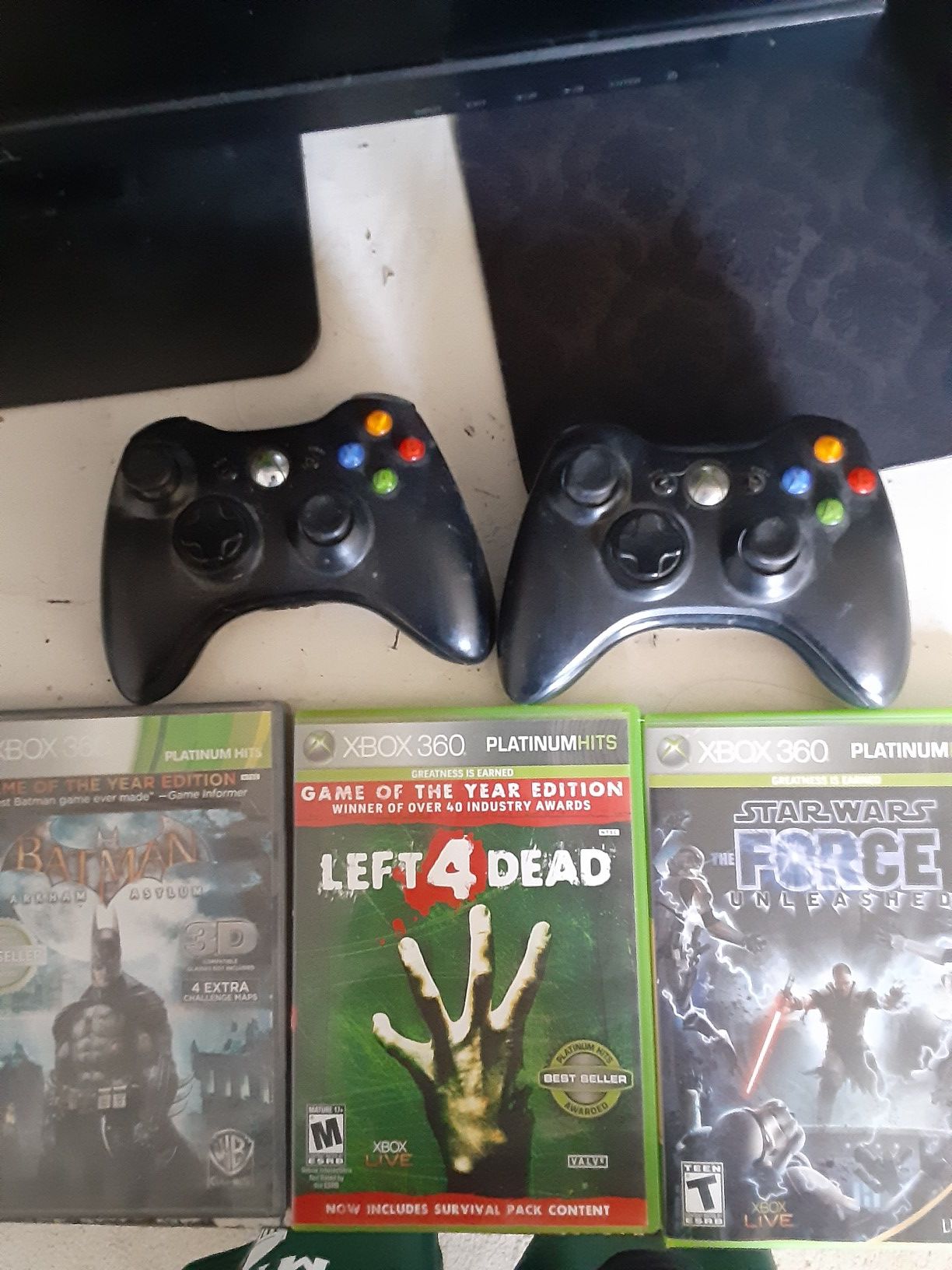 Two xbox 360 controllers and a few games