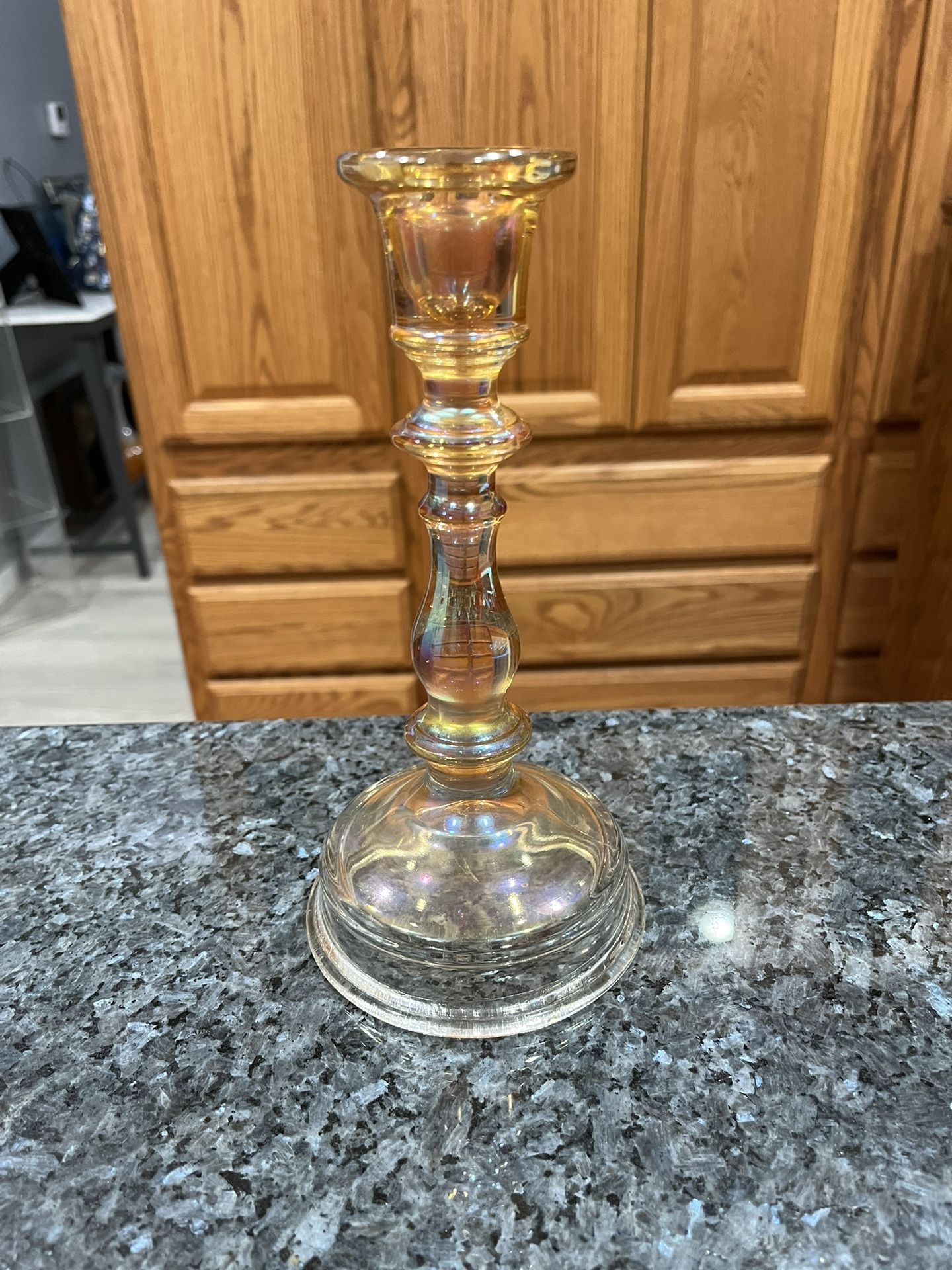 Vintage Iridescent Marigold Candlestick Holder. Size approximately 8 1/2 inches tall. Preowned Excellent condition. Has been on display in a cabine
